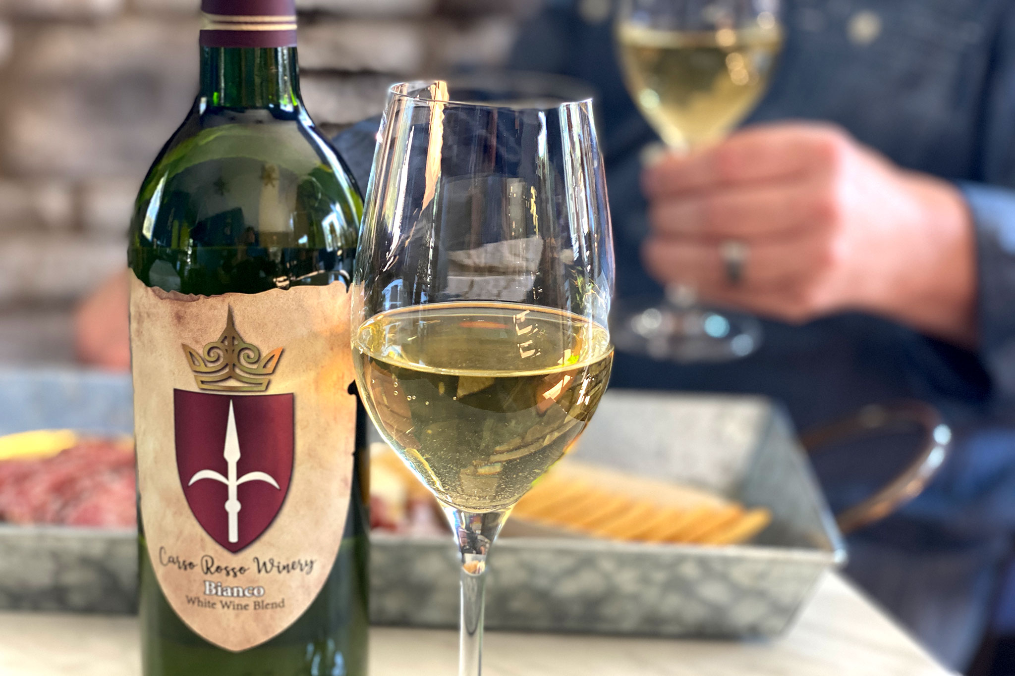 Cheers! Toasting with a glass of Carso Ross Chardonnay