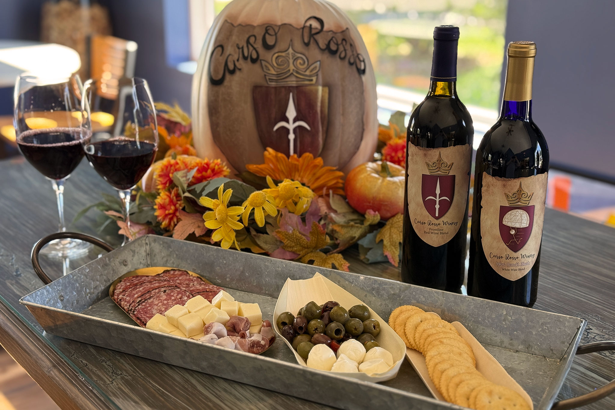 charcuterie platter and wine amidst fall decorations